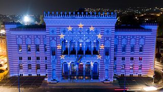 The European Union flag is projected on the National Library building in Sarajevo, Bosnia, Oct. 12, 2022.