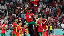 Morocco's Yahia Attiyat Allah (25) celebrates with teammates after the World Cup quarterfinal match against Portugal in Doha, Qatar, Saturday, Dec. 10, 2022.