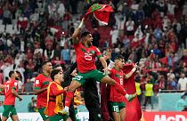Morocco's Yahia Attiyat Allah (25) celebrates with teammates after the World Cup quarterfinal match against Portugal in Doha, Qatar, Saturday, Dec. 10, 2022.