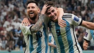 Argentina's Lionel Messi, left, and Argentina's Julian Alvarez celebrate after scoring during the World Cup semifinal soccer match against Croatia, 13 December 2022