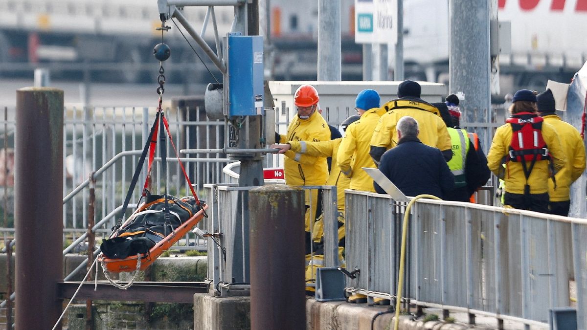Rescue workers hoist a body bag on a stretcher amid a rescue operation of a missing migrant boat, at the Port of Dover, in Dover, Britain December 14, 2022.