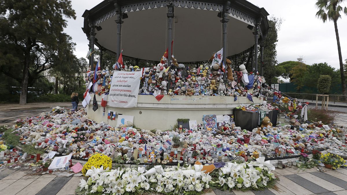 Flowers pile up at a makeshift memorial in a park on the Nice's famed Promenade des Anglais.