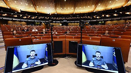 Volodymyr Zelenskyy is seen on screen as he remotely addresses the Parliamentary Assembly of the Council of Europe in Strasbourg on October 13.