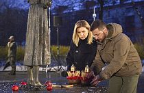 Ukrainian President Volodymyr Zelenskyy and his wife Olena pay tribute at a monument to victims of the Holodomor
