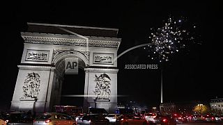 France supporters celebrate France's victory with fireworks at the Arc de Triomphe after the World Cup semifinal soccer match between France and Morocco
