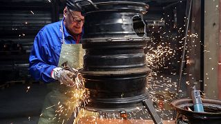 A worker of Lithuanian metal processing company 'Kalvis' welds old wheel rims to create heating stoves for Ukrainian civilians and soldiers in Siauliai, Lithuania.