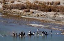  Afghans try to repair a dam on a river as seen from the British forces forward operating base Sterga II at Helmand province in southern Afghanistan, Dec. 16, 2013.