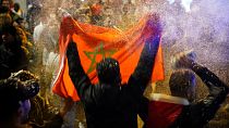 A man waves a Moroccan flag after the team's World Cup win over Spain