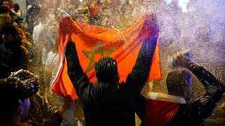 A man waves a Moroccan flag after the team's World Cup win over Spain