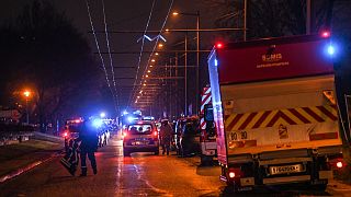 Firefighters and rescuers work in a building of the Mas-Du-Taureau quarter where a fire caused many victims, including children, on December 16, 2022 in Vaulx-en-Velin.