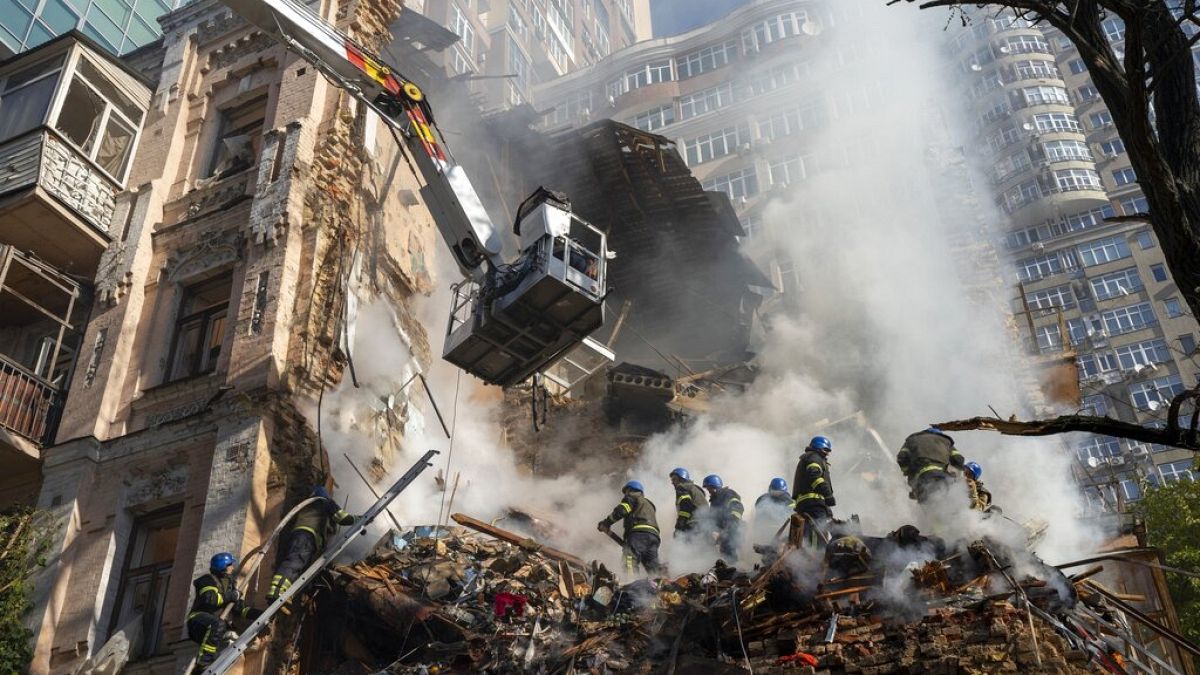Firefighters work after a drone attack on buildings in Kyiv, Ukraine, Oct. 17, 2022. 
