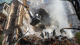 Firefighters work after a drone attack on buildings in Kyiv, Ukraine, Oct. 17, 2022. 