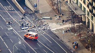 Debris is scattered on the street outside the building where the aquarium burst. 