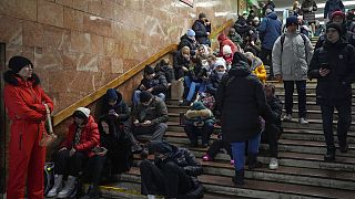 People rest in the subway station, being used as a bomb shelter during a rocket attack in Kyiv, Ukraine, Friday, Dec. 16, 2022.