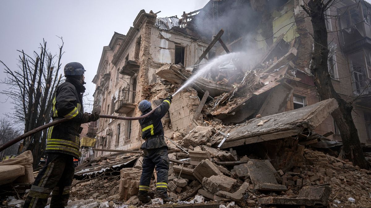 Ukrainian State Emergency Service firefighters work to extinguish a fire at the building which was destroyed by a Russian attack in Kryvyi Rih, Ukraine, Friday, Dec. 16, 2022.