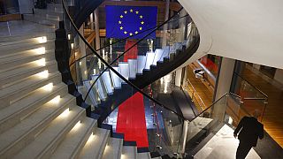 FILE - A man walks down stairs during a special session on lobbying at the European Parliament in Strasbourg, eastern France, Dec. 12, 2022. 