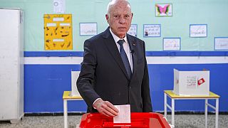 Tunisia's President Kais Saied casts his ballot as he participates in the legislative elections in Tunis, Saturday, Dec. 17, 2022. 