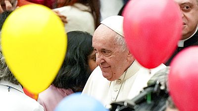 Pope Francis greets children at the end of an audience with children assisted by the Santa Marta dispensary in the Paul VI Hall, at the Vatican, Sunday, Dec. 18, 2022.