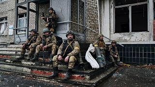 Ukrainian soldiers rest near their position in Bakhmut