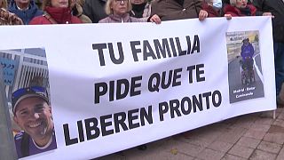 "Your family asks for your quick release," says the banner protesters held in Madrid.
