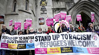 Protesters gathered outside the court in London