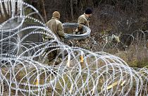 US soldiers serving in NATO-led peacekeeping force KFOR, place a barbed wire at a checkpoint near the northern Kosovo border crossing Sunday, Dec. 18, 2022.