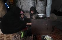 Syrian family trying to stay warm in winter.