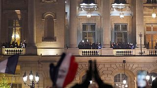 France supporters applaud the French team at the balcony of the Hotel Crillon.