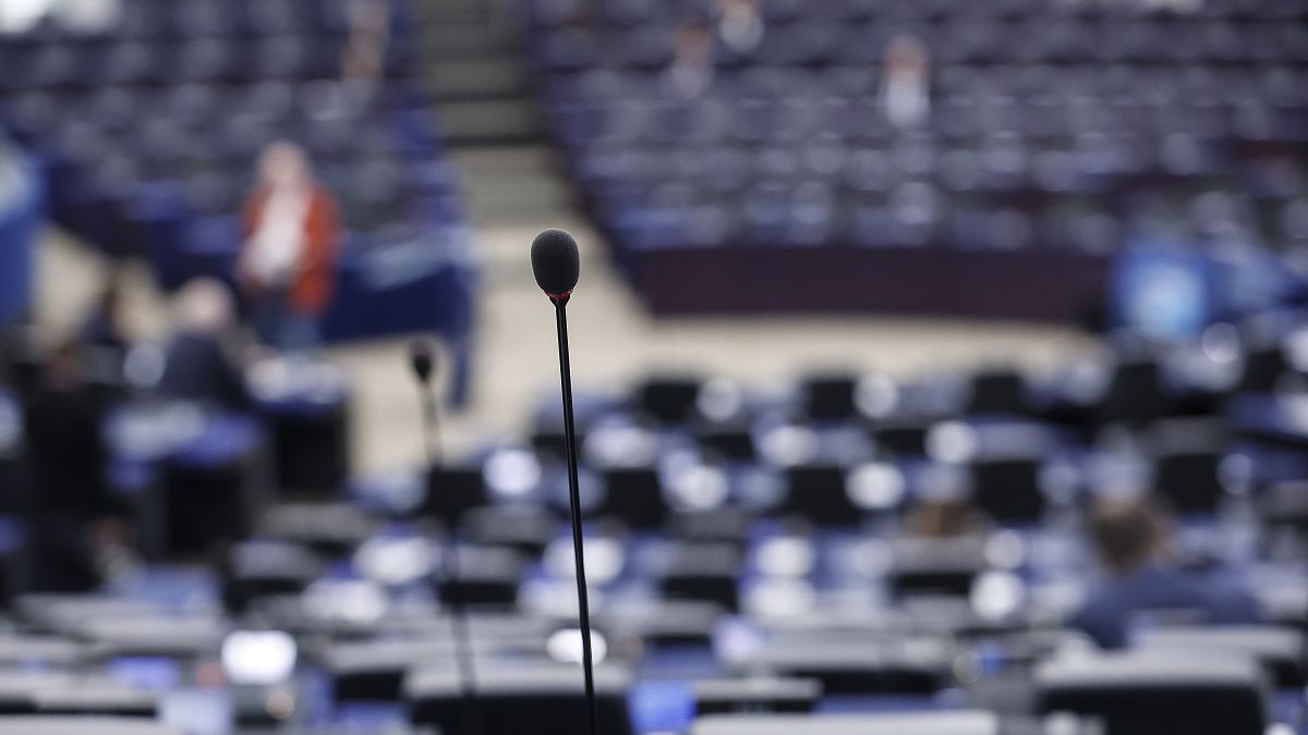 A microphone is pictured in an almost empty hemicycle of the European Parliament during a debate. in Strasbourg, eastern France, Tuesday Dec 13, 2022