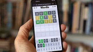 A Wordle game is seen on a mobile phone