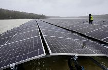 Solar panels are installed at a floating photovoltaic plant on a lake in Haltern.