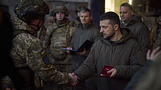 Le président ukrainien Volodymyr Zelensky récompense un militaire à Bakhmout, en Ukraine, mardi 20 décembre 2022.