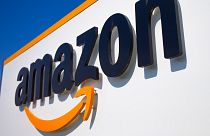 FILE - A company logo is seen at the entrance of Amazon, in Douai, northern France, on April 16, 2020