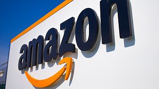 FILE - A company logo is seen at the entrance of Amazon, in Douai, northern France, on April 16, 2020