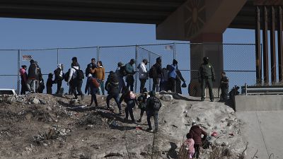Migrants cross the U.S.-Mexico border from Ciudad Juarez, Mexico, and turn themselves into U.S. Border Patrol agents, Monday, Dec. 19, 2022.