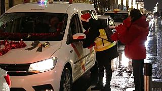 Taxi drivers take the elderly for a drive through Madrid to show them the lights