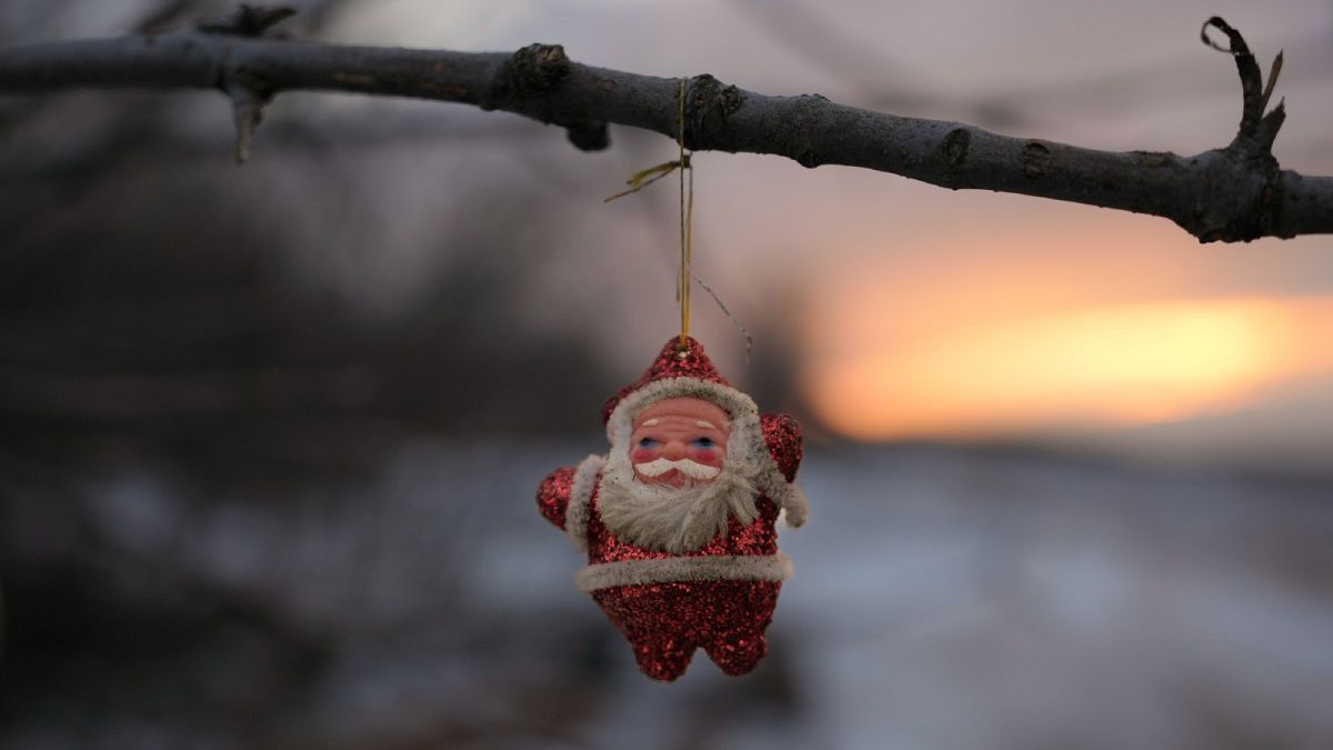 A Santa Claus Christmas decoration hangs from a tree branch outside a bunker at a frontline position outside Popasna, the Luhansk region, in eastern Ukraine, Feb. 16, 2022