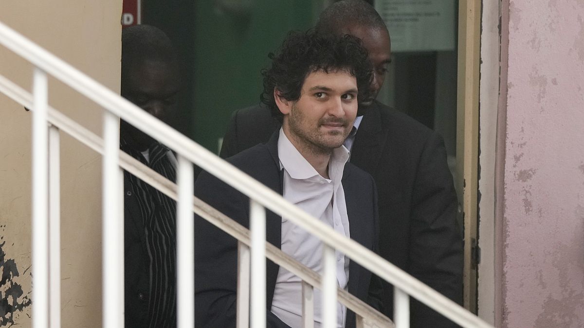 FTX founder Sam Bankman-Fried, is escorted from the Magistrate Court in Nassau, Bahamas, Wednesday, Dec. 21, 2022