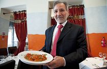 Ahmed Aslam Ali, the owner of the Shish Mahal restaurant in Glasgow, is pictured with a plate of Chicken Tikka Masala in his restaurant, on July 29, 2009. 