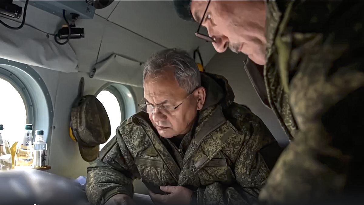 Russian Defence Minister Sergei Shoigu looks at documents aboard a military helicopter at an undisclosed location in Ukraine, 18 December 2022