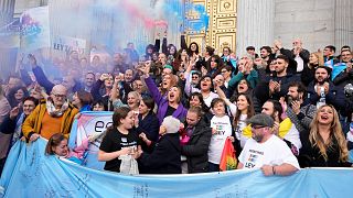 People celebrate the new Transgender Law on the steps of the parliament in Madrid, Spain.