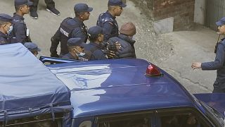 Nepalese police escort Charles Sobhraj to the immigration office, in Kathmandu, Nepal.