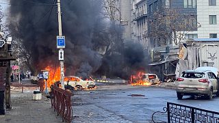 Cars burn after Russian shelling in the Ukrainian city of Kherson, Saturday 24 December 2022