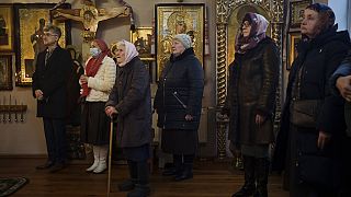 Ukrainians attend a Christmas mass at an Orthodox Church in Bobrytsia, outskirts of Kyiv, Ukraine, Sunday, Dec. 25, 2022. 