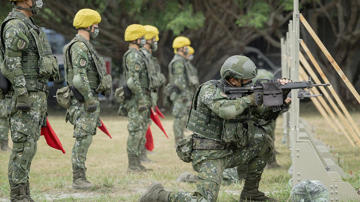 In this photo released by the Taiwan Presidential Office, Taiwanese soldiers go through a drill at a camp in Hualien, in eastern Taiwan on Tuesday, Sept. 6, 2022. 