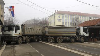 Trucks are being used as makeshift barricades in the northern Kosovo town of Mitrovica. 