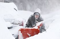 Mike Gippon plows snow in the driveway outside his home in Buffalo on Monday.