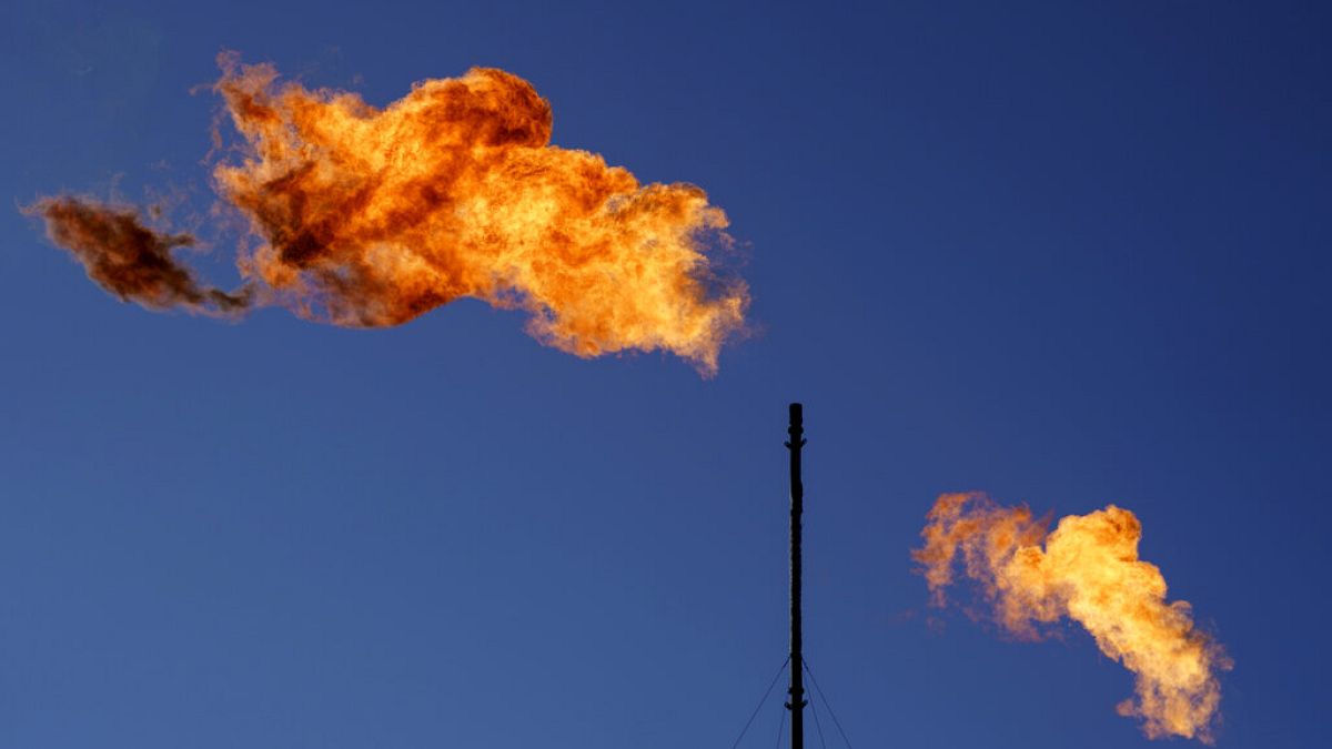 Flares burn off methane and other hydrocarbons at an oil and gas facility in Lenorah, Texas, Oct. 15, 2021