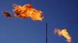 Flares burn off methane and other hydrocarbons at an oil and gas facility in Lenorah, Texas, Oct. 15, 2021