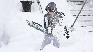 أمريكي يجرف الثلج بعيدًا عن منزله في بوفالو، نيويورك. 2022/12/27